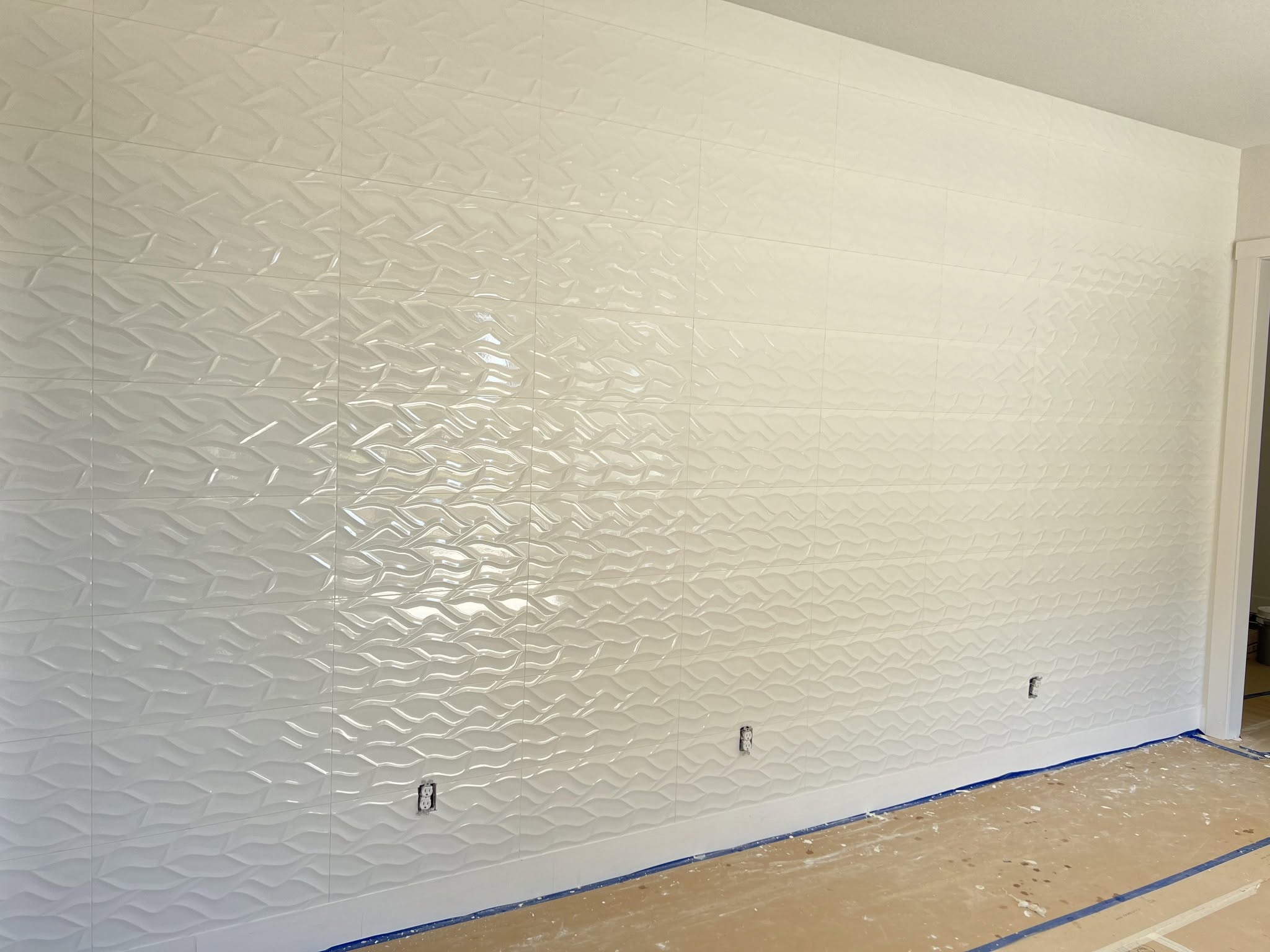 3D wave-textured tile wall installed by Mederus Services Inc.